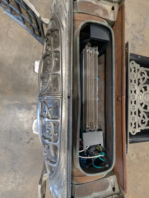 Electric components fitted inside the vintage fireplace during the conversion
